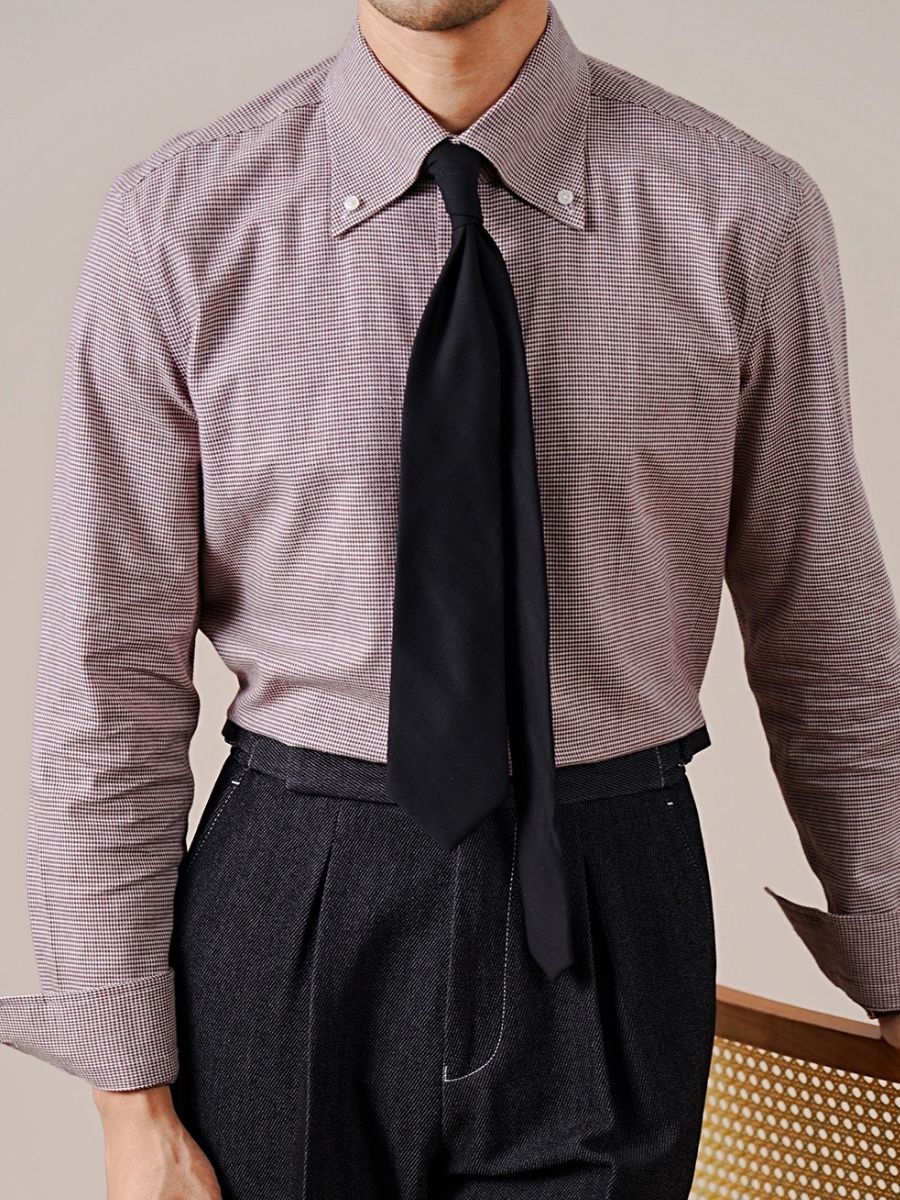 Man wearing slim-fit burgundy check dress shirt with button-down collar and black tie